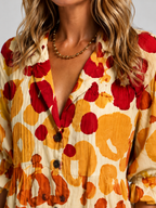 Printed V-neck button-front shirt dress close-up with embroidered-looking fabric texture