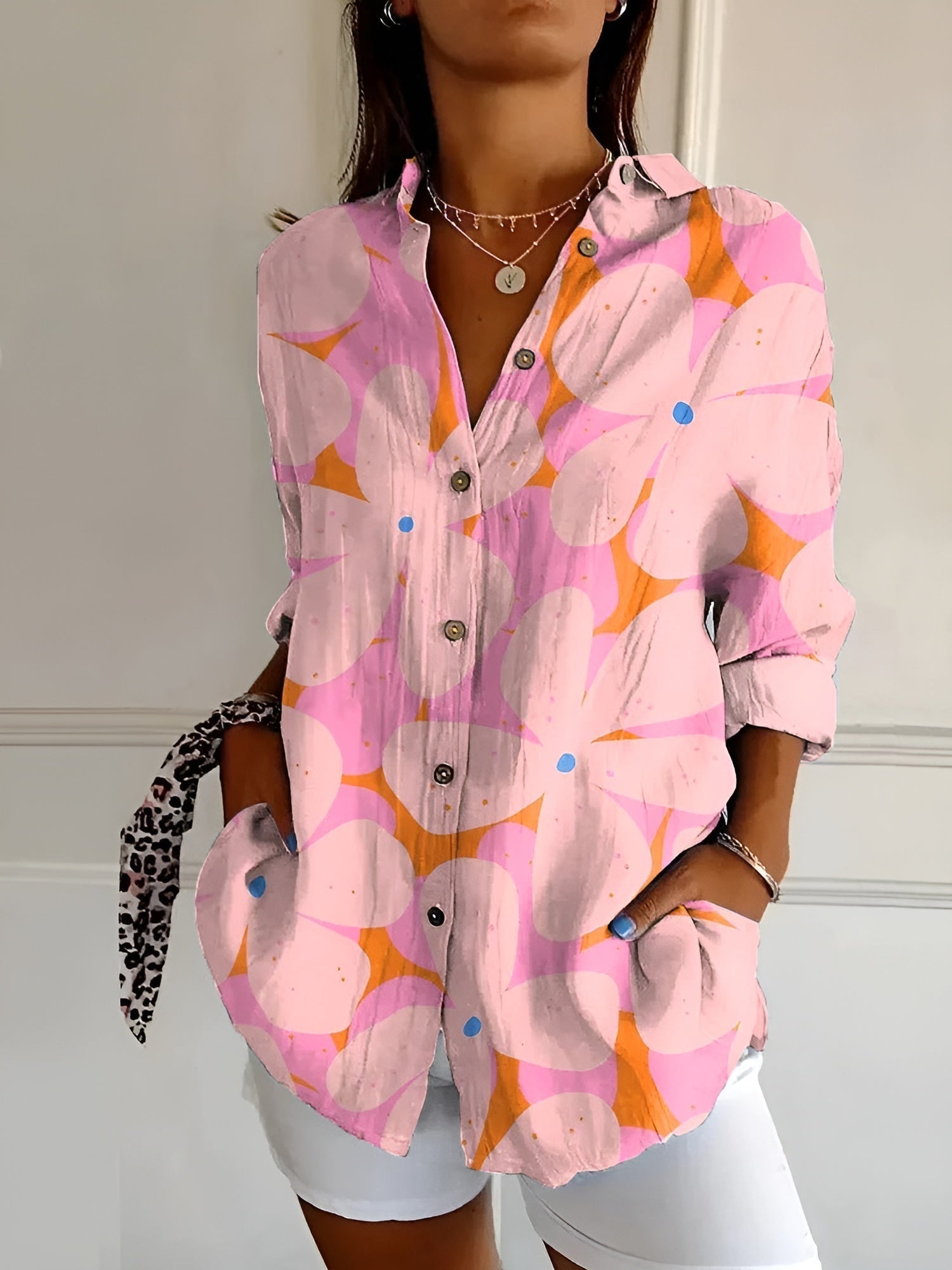 Women’s printed split-neck blouse with button front, long sleeves rolled up; pink/orange abstract
