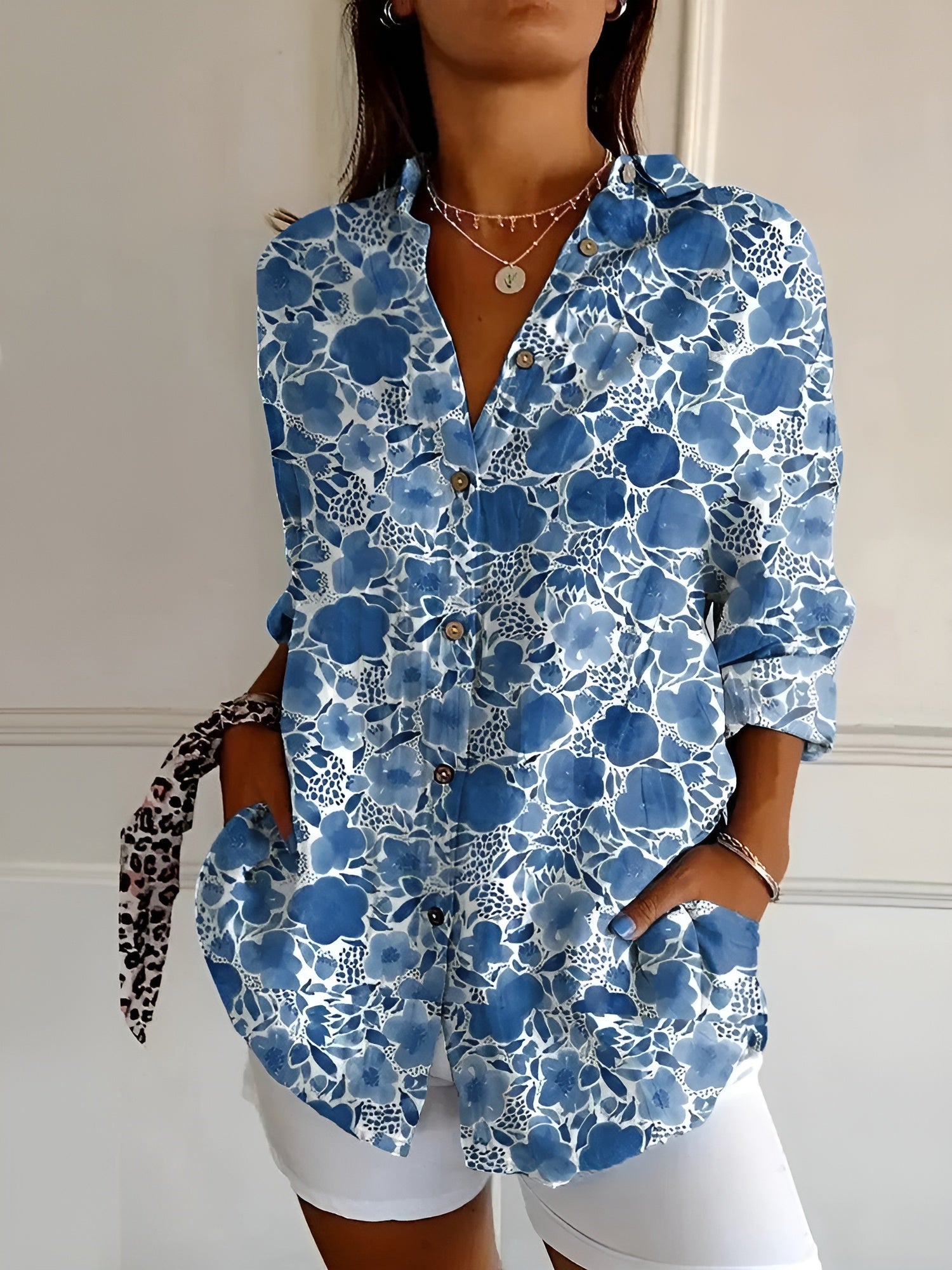 Women’s printed split-neck blouse with button front, rolled-up long sleeves; blue floral pattern