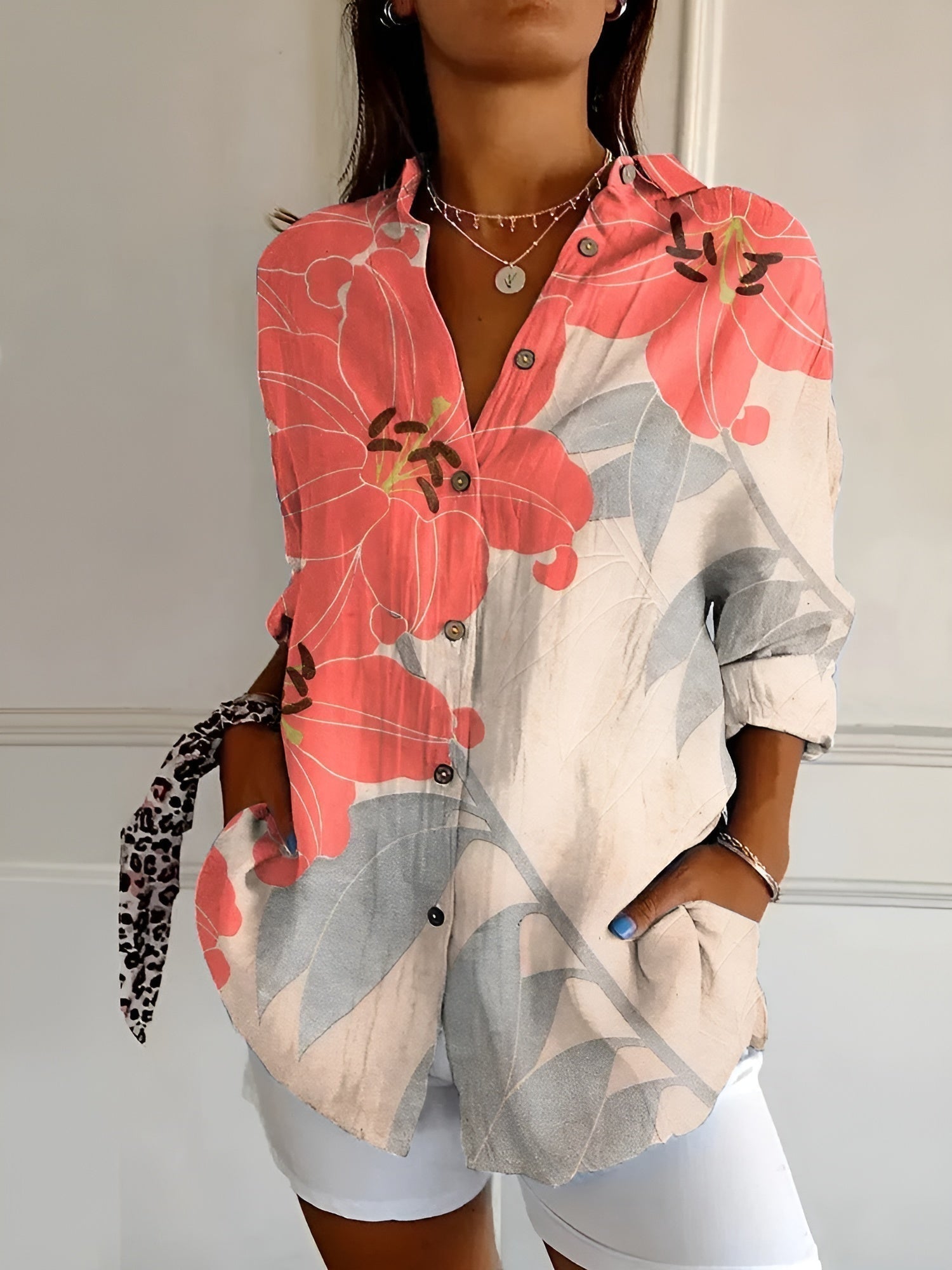 Women’s printed split-neck blouse with button front, rolled-up long sleeves; red and gray floral