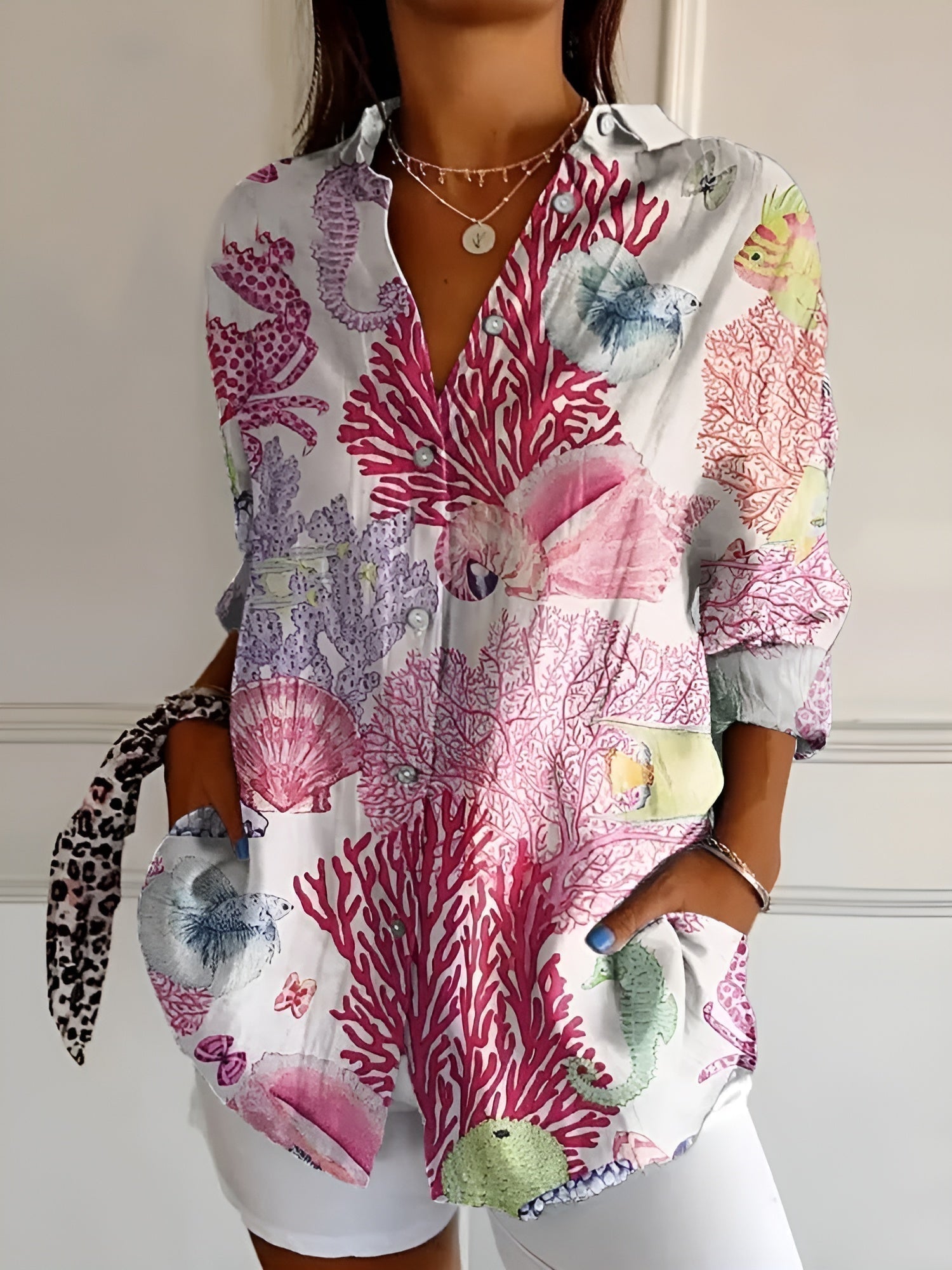 Women’s printed split-neck blouse with button front, rolled-up long sleeves; pink and purple coral print