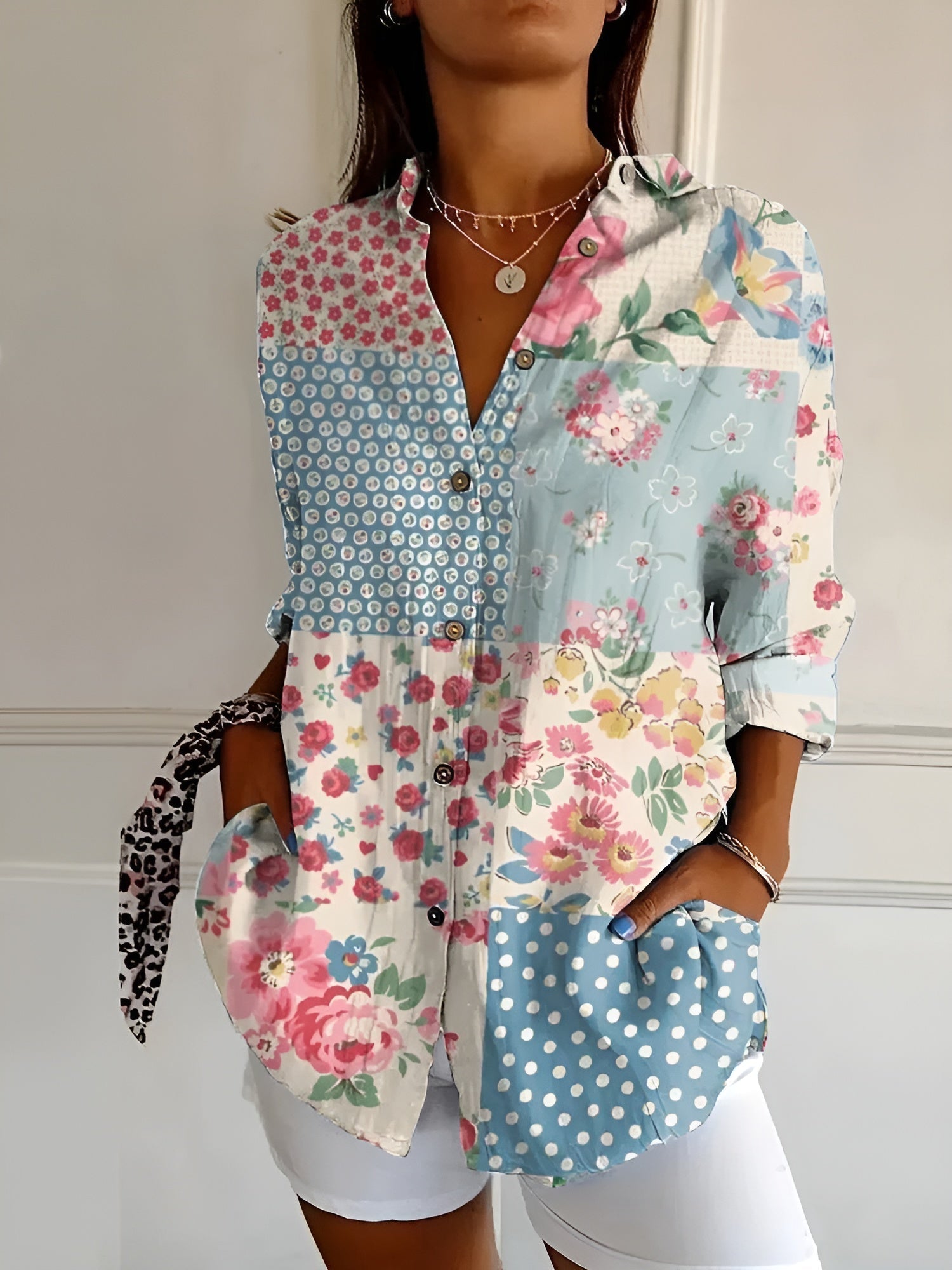 Women’s printed split-neck blouse with button front, rolled-up long sleeves; blue and floral patchwork