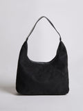 Black suede shoulder bag with top zipper and curved handle