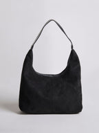 Black suede shoulder bag with top zipper and curved handle
