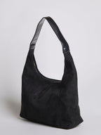 Black shoulder bag with top zipper, curved handle, and front seam panel