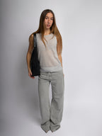 Black shoulder bag on model with curved handle and top zipper opening
