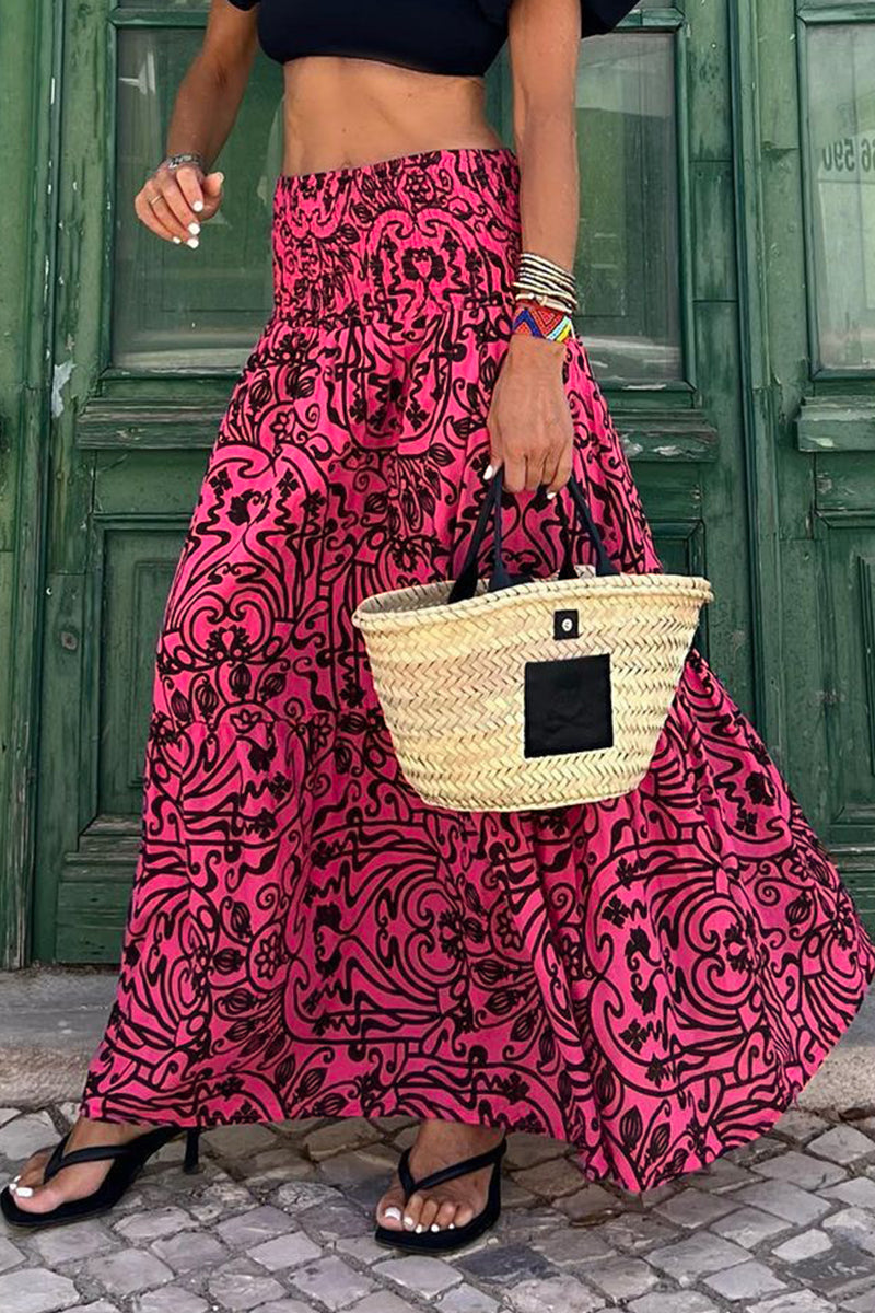 Women's high-waist maxi skirt with bold pink and black swirl print, tiered flow