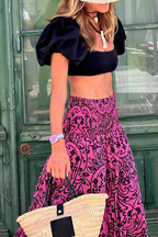 Women's high-waist maxi skirt with pink and black swirl print, ruffled tiered look