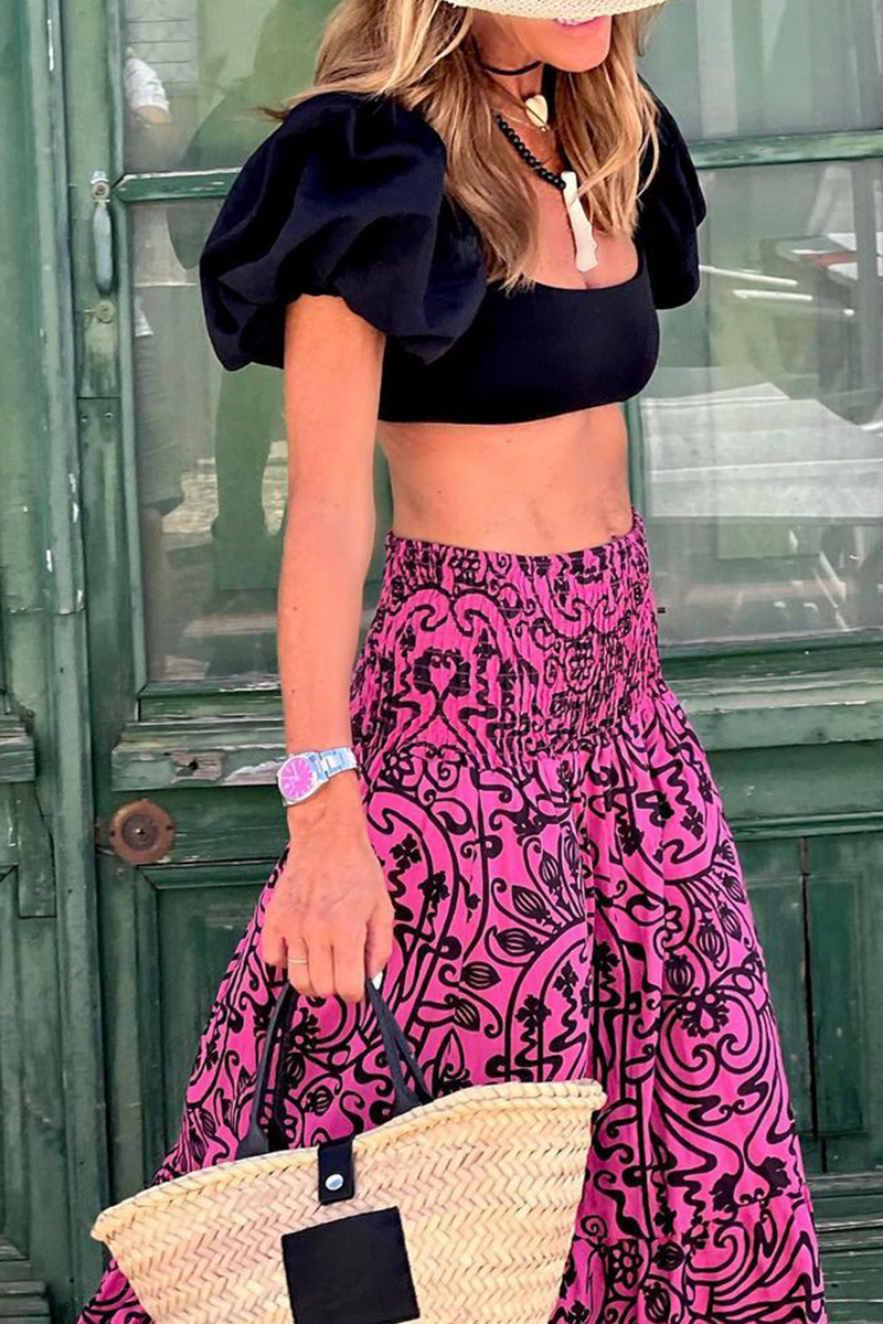 Women's high-waist maxi skirt with pink and black swirl print, ruffled tiered look