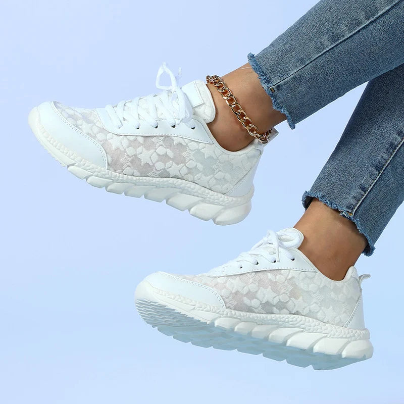 Women’s white lace-up sneakers with patterned fabric upper and chunky tread sole
