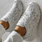 Women’s white lace-up sneakers with patterned fabric and side panel stitching detail