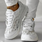 Women’s white lace-up sneakers with patterned upper and thick sole cushioning