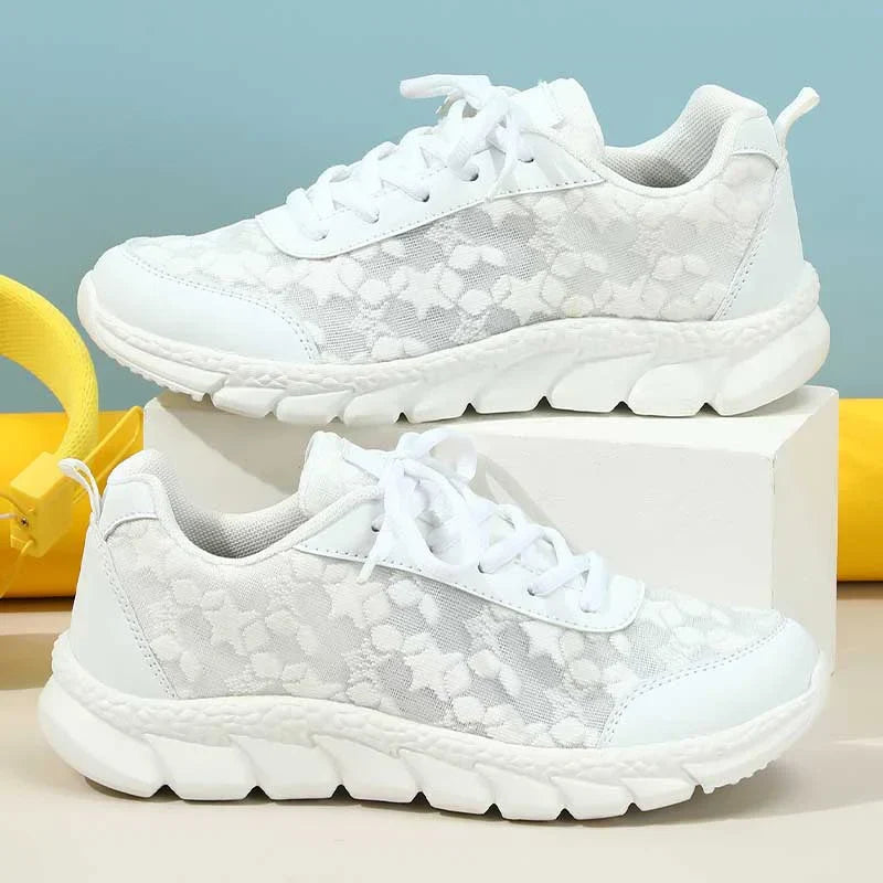 Women’s white lace-up sneakers with patterned upper, front lace eyelets, chunky sole