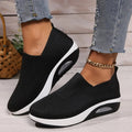 Women's black slip-on sneakers with knit upper and white air-cushion sole