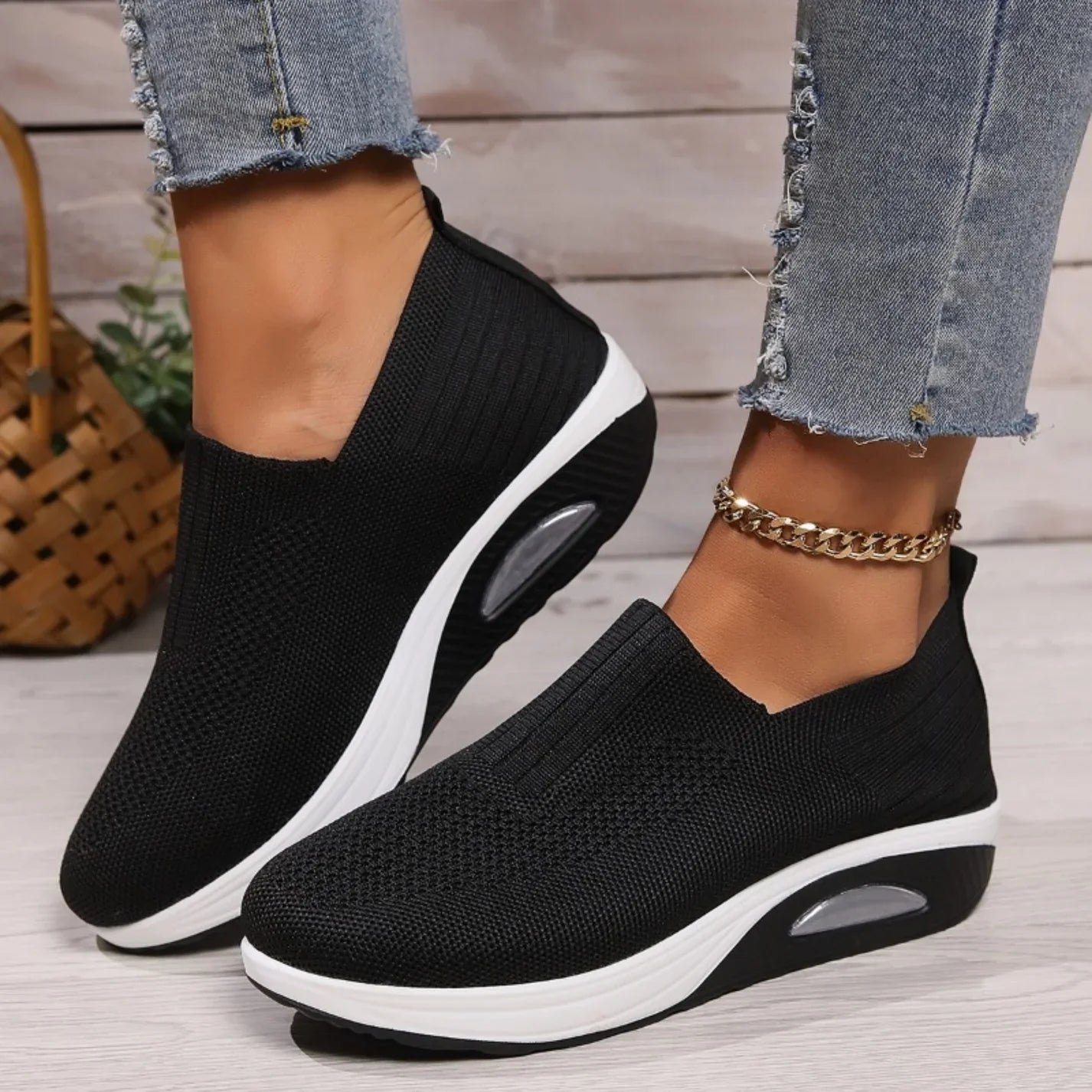Women's black slip-on sneakers with knit upper and white air-cushion sole