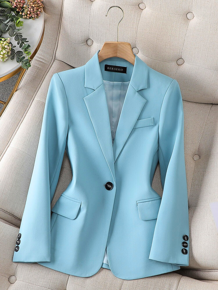 Light blue tailored blazer with notch lapels, flap pockets, and button front