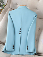 Light blue blazer back view with center seam and buttoned sleeve cuffs