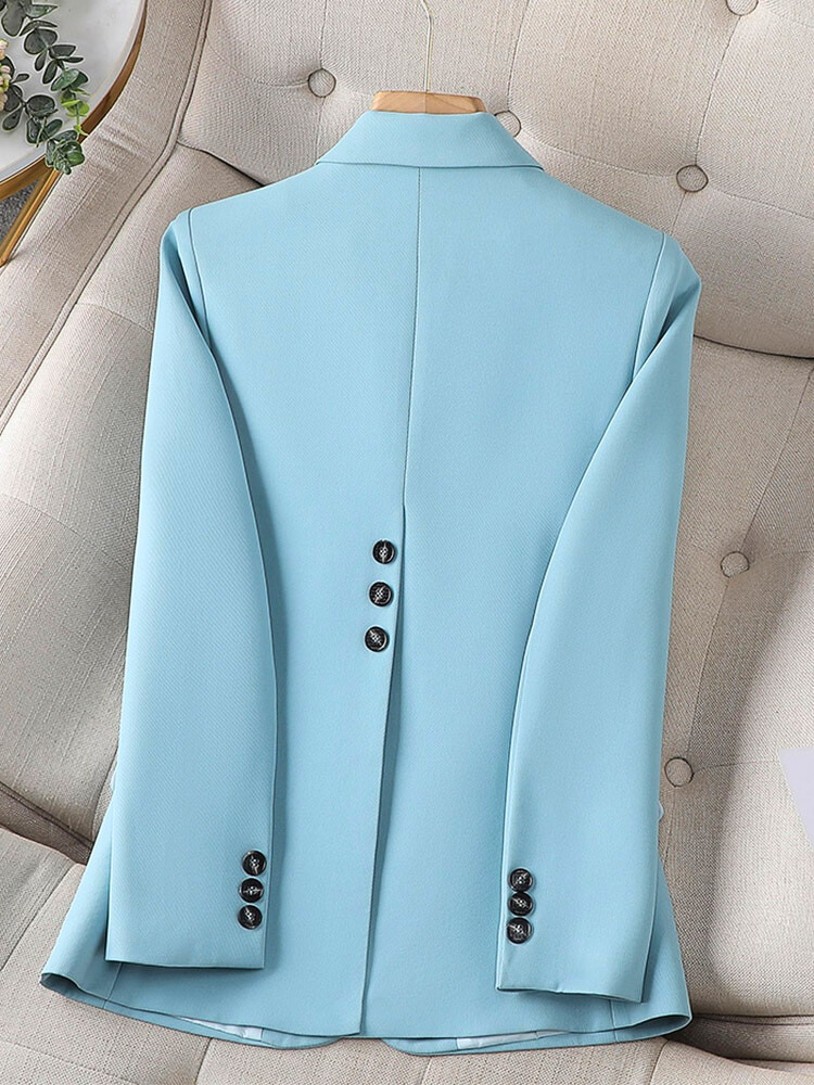 Light blue blazer back view with center seam and buttoned sleeve cuffs