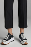 Women’s black trainers, white laces, leather platform sole, with cropped pants