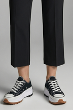 Women’s black trainers, white laces, leather platform sole, with cropped pants