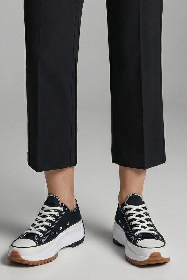Women’s black trainers, white laces, leather platform sole, with cropped pants