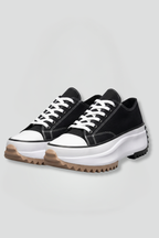 Women’s black trainers with white laces, chunky leather platform sole