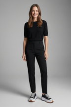 Women’s black trainers with leather platform sole worn with black trousers