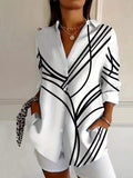 White button-up long sleeve blouse with V-neck and bold black stripe pattern