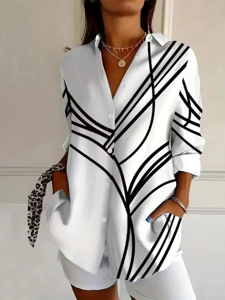 White button-up long sleeve blouse with V-neck and bold black stripe pattern