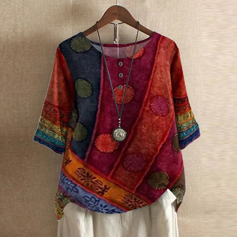Women’s red blouse with multicolor circle motifs, short sleeves, round neck