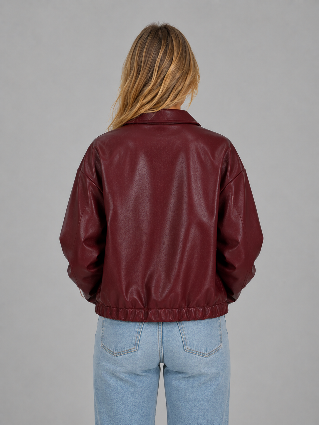 Burgundy leather zip jacket, back view, ribbed waist hem and relaxed cropped fit