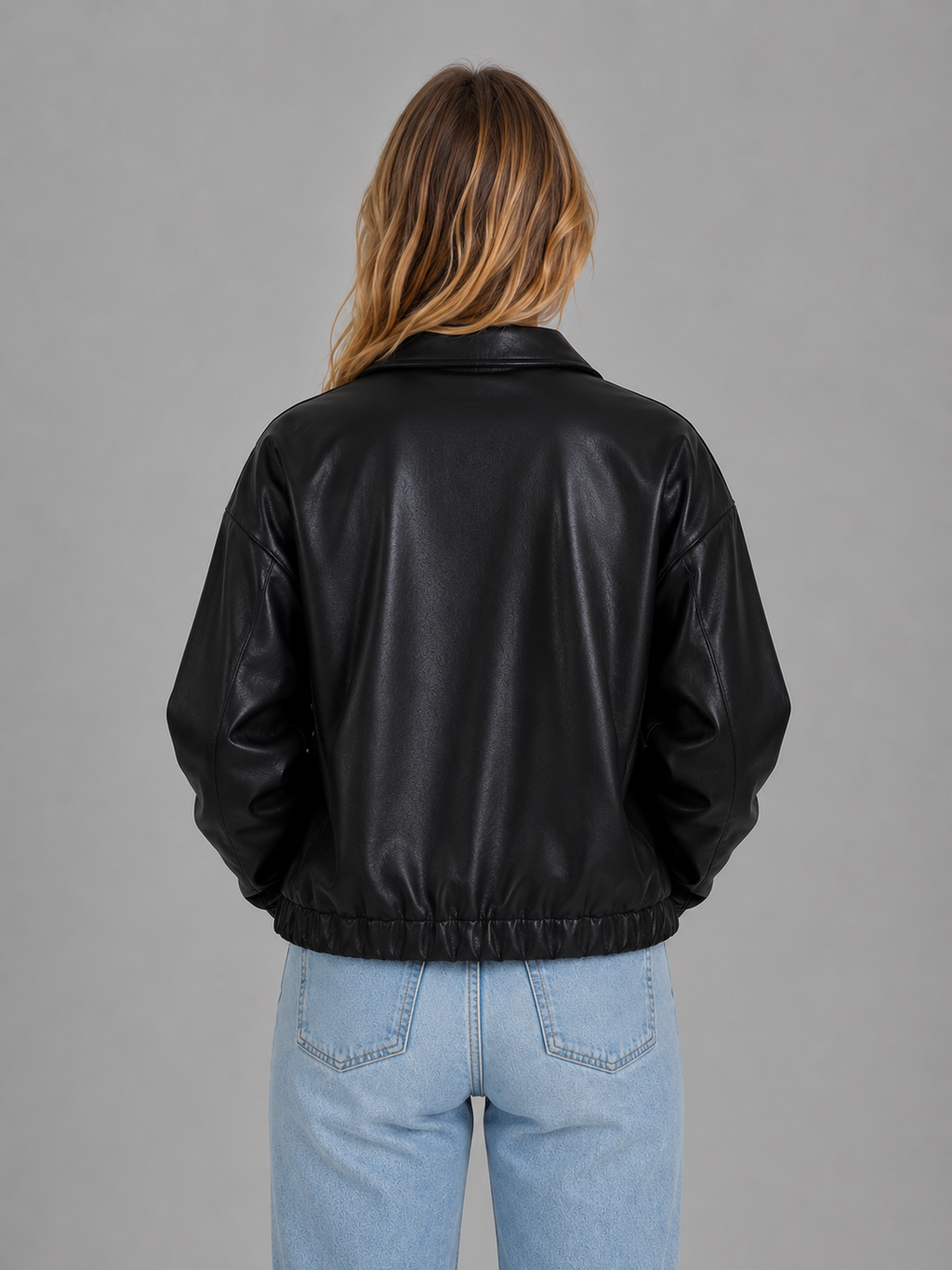 Black leather zip jacket, back view, ribbed waist hem and relaxed cropped fit
