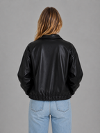 Black leather zip jacket, back view, ribbed waist hem and relaxed cropped fit