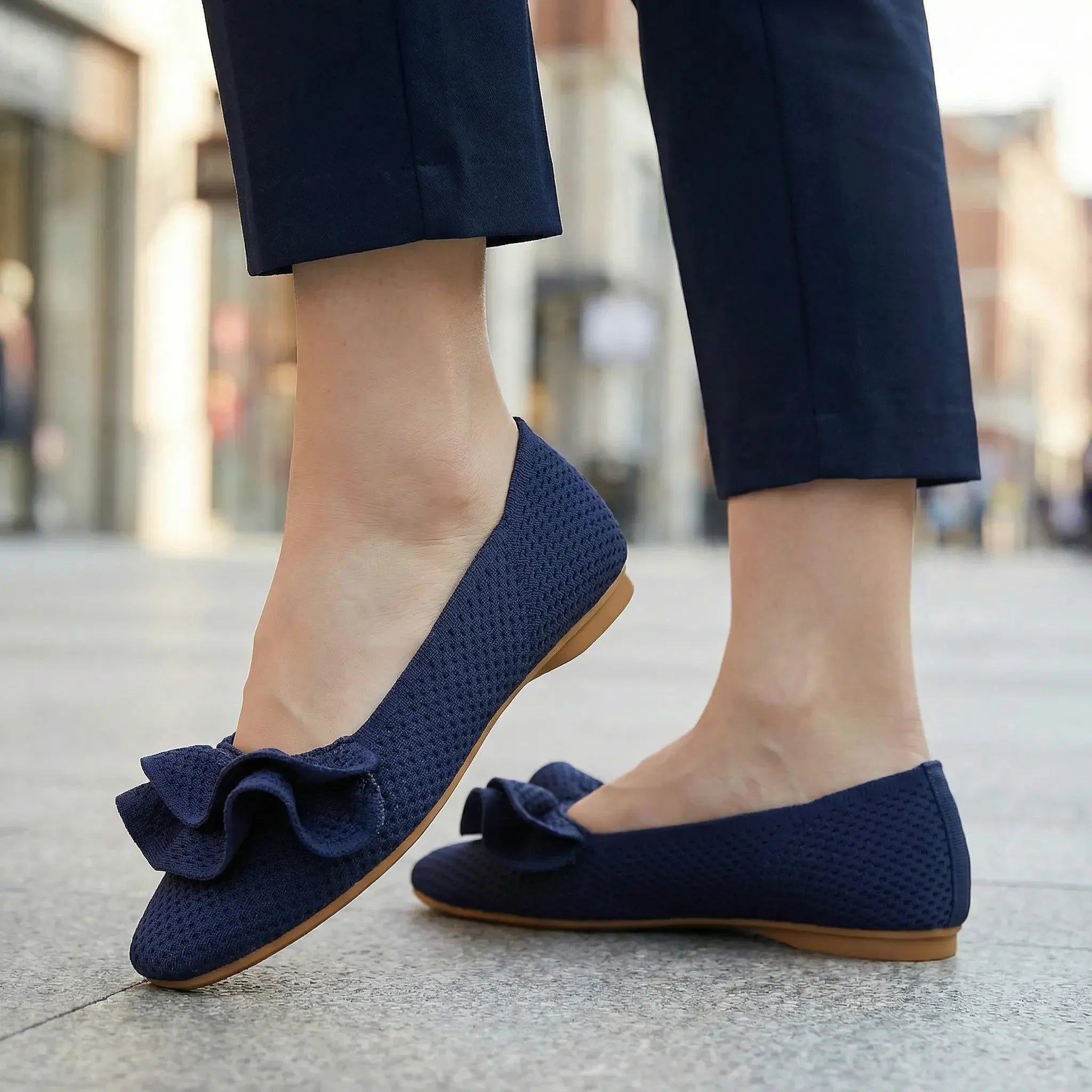 Navy wide-fit slip-on knit shoes with arch support, bow strap on flat sole