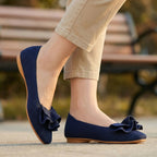 Navy wide-fit slip-on knit shoes with arch support, ruffled bow and tan outsole