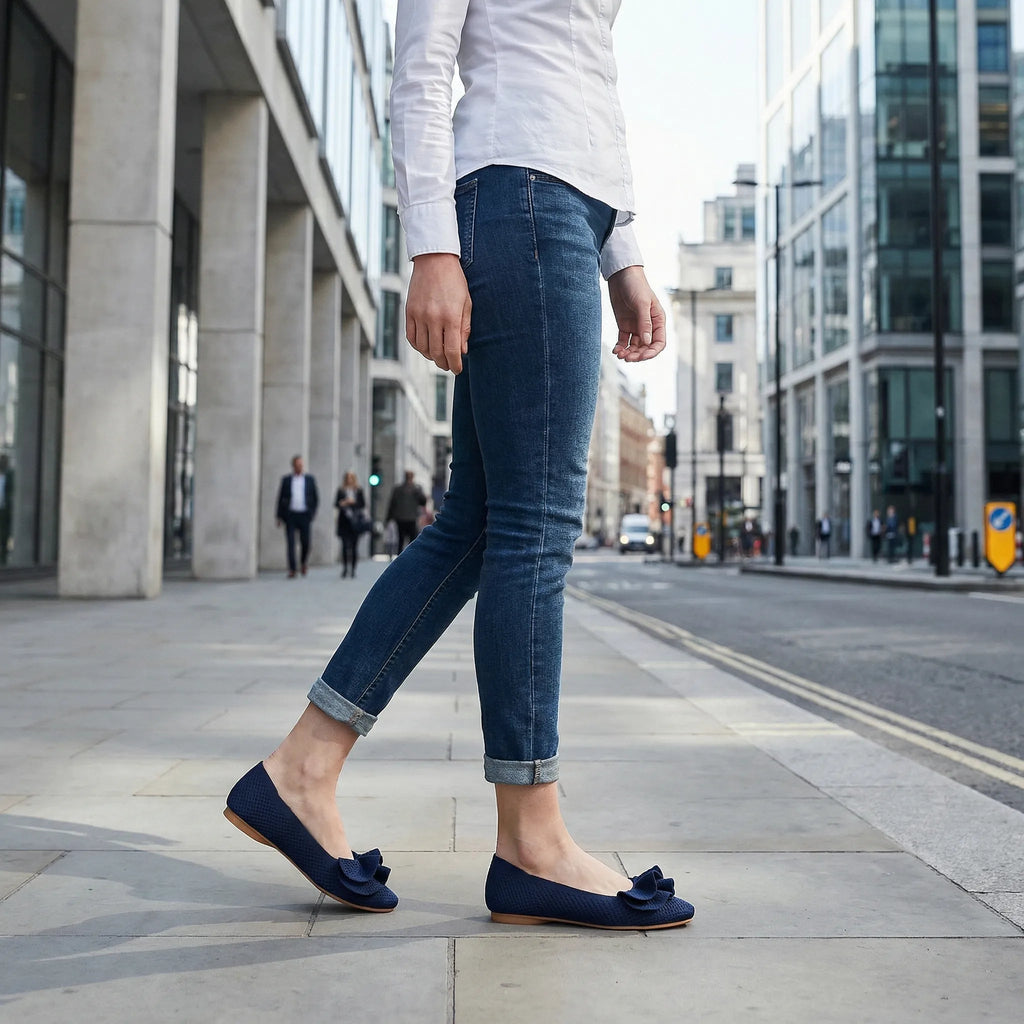 Navy wide-fit slip-on knit shoes with arch support, worn with cuffed jeans