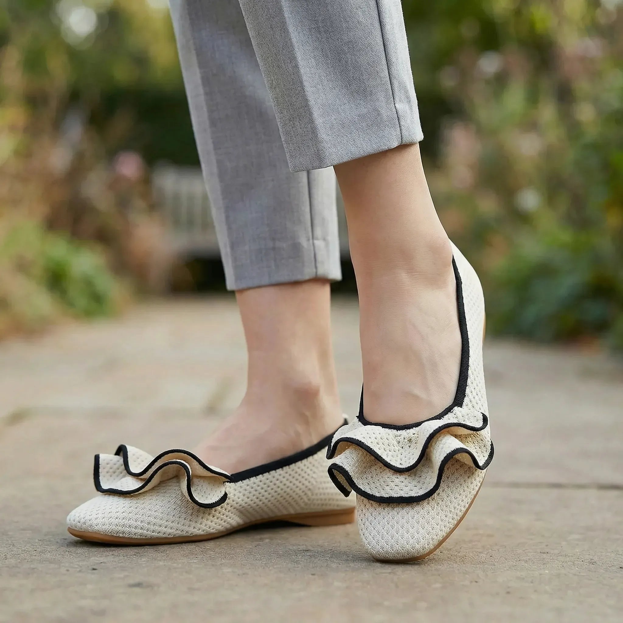 Wide-fit knit slip-on shoes, white with black trim and bow at toe on flat sole