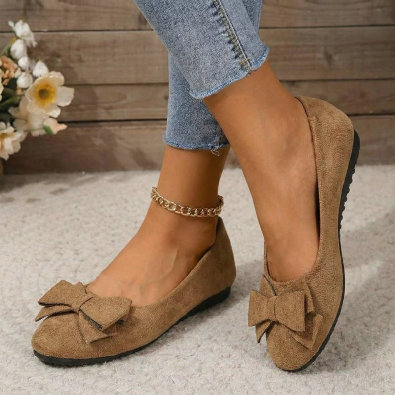 Beige faux suede ballet flats with bow detail and gold chain ankle strap