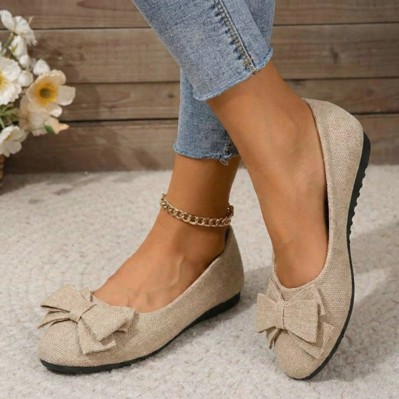 Light beige faux suede ballet flats with bow and gold chain ankle strap
