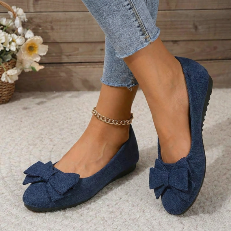 Navy blue faux suede ballet flats with large bow and gold chain ankle strap