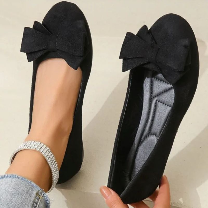 Cushioned ballet flats in black faux suede with bow detail at the toe