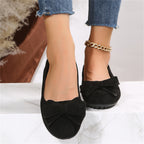 Wide fit cushioned ballet flats in black faux suede with bow at front, worn