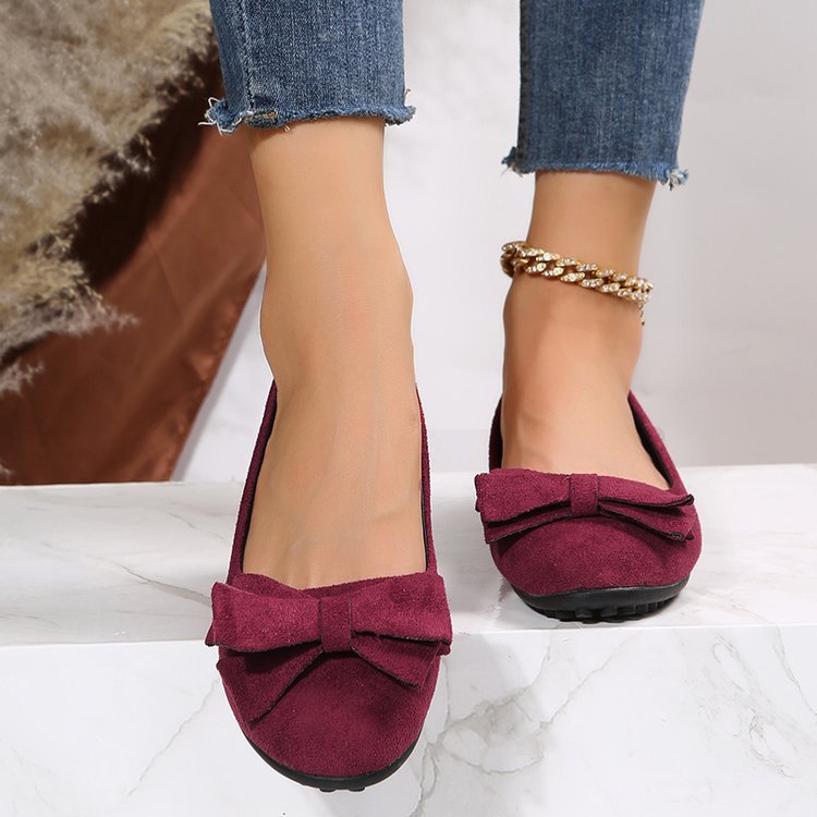Wide fit cushioned ballet flats in burgundy faux suede with bow at toe, worn