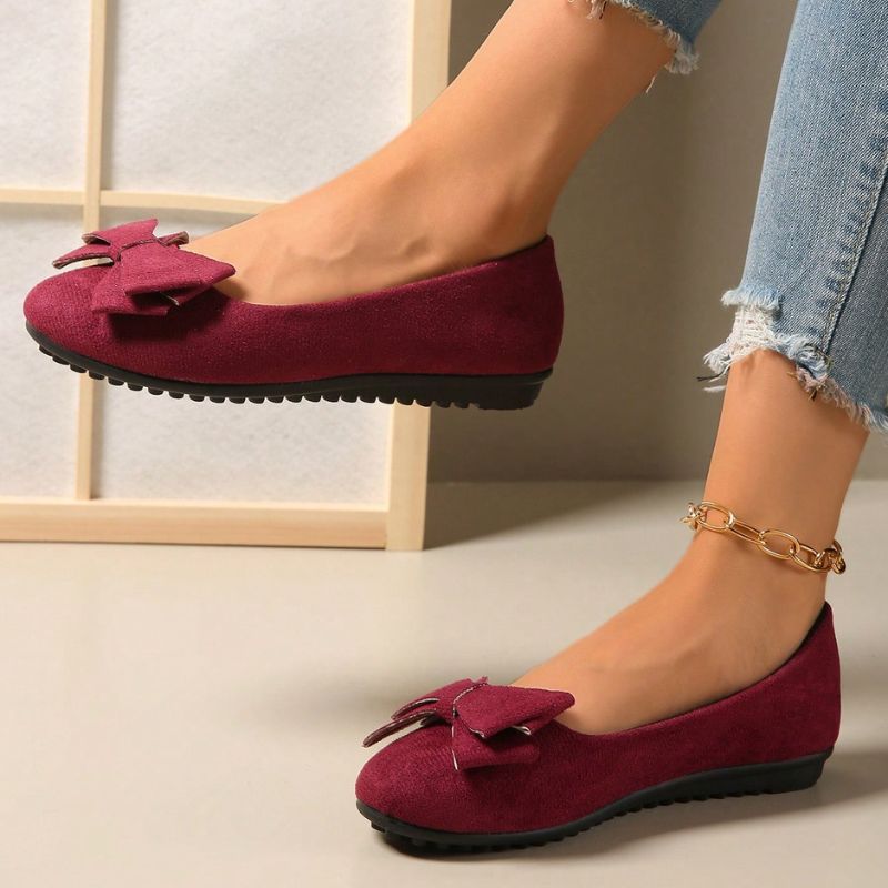 Wide fit cushioned ballet flats in burgundy faux suede with bow at front, side view