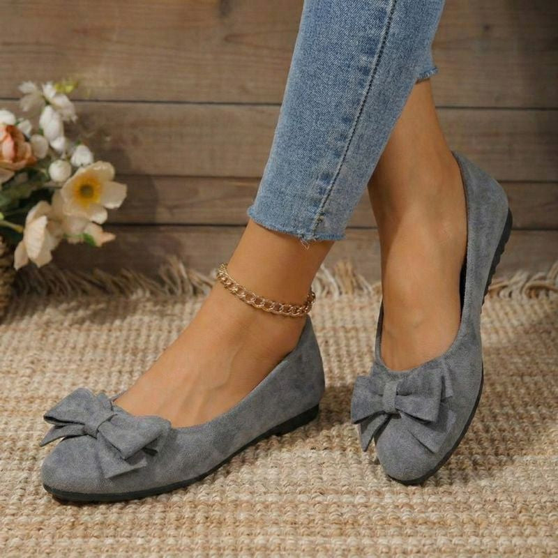 Cushioned ballet flats in light grey faux suede with bow detail at the toe