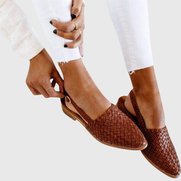 Woven orthopedic mule, flat slip-on with pointed toe in dark brown, being worn