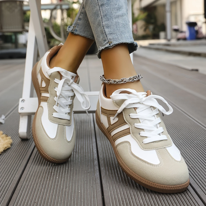 Women’s khaki and white lace-up sneakers, pair view on outdoor boardwalk