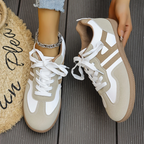 Women’s khaki and white lace-up sneakers close-up, textured side panels