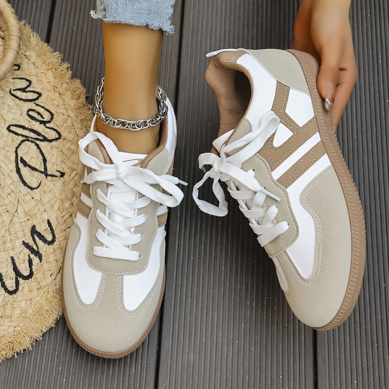 Women’s khaki and white lace-up sneakers close-up, textured side panels