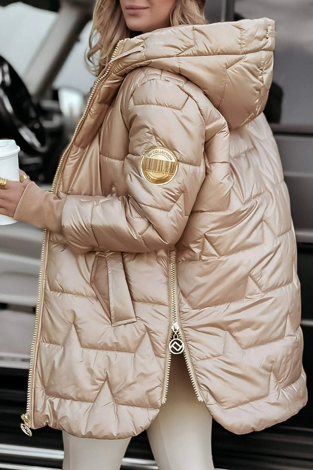 Beige hooded puffer jacket with full zipper and padded shoulder detail